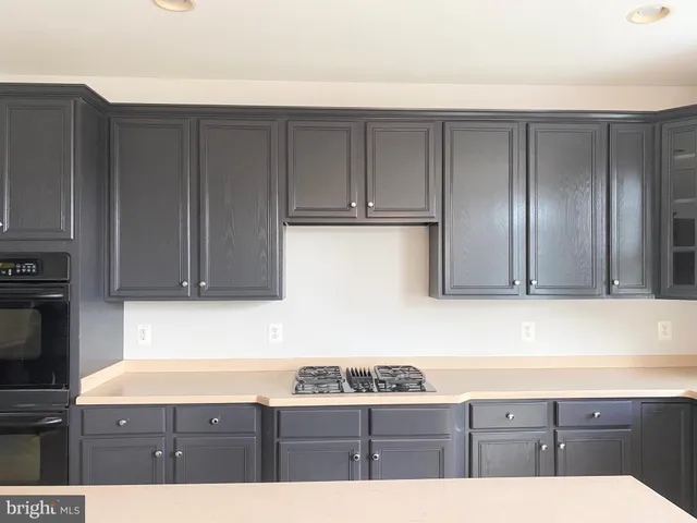 a kitchen with granite countertop cabinets and window