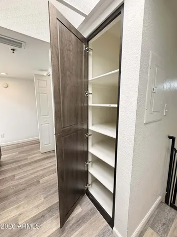 a view of a hallway with wooden floor