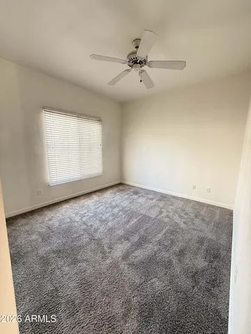 a view of staircase with wooden floor and fan