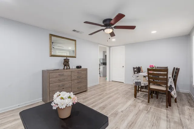 a view of a dining room with furniture and wooden floor