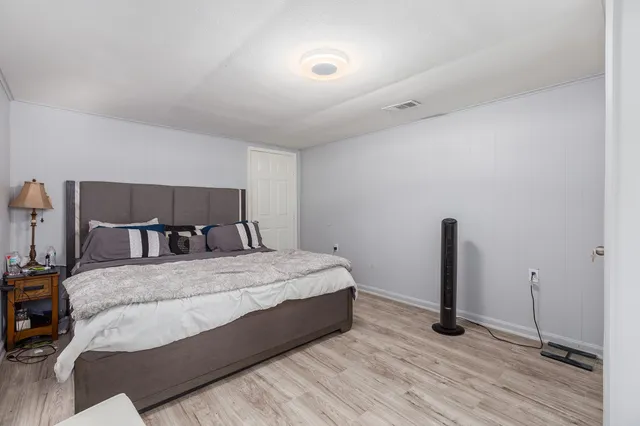 a large bed sitting in a bedroom next to a cabinet
