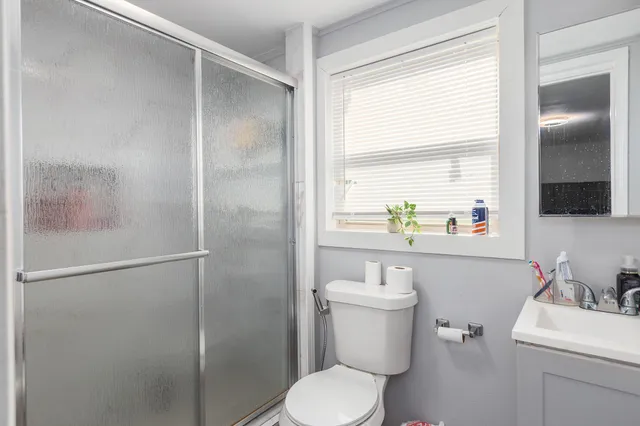a bathroom with a toilet sink and shower