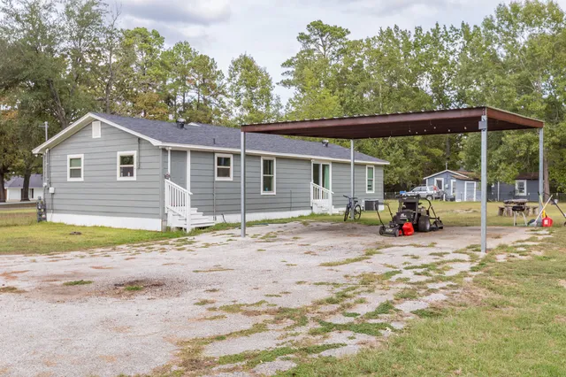 a view of a house with backyard and sitting area