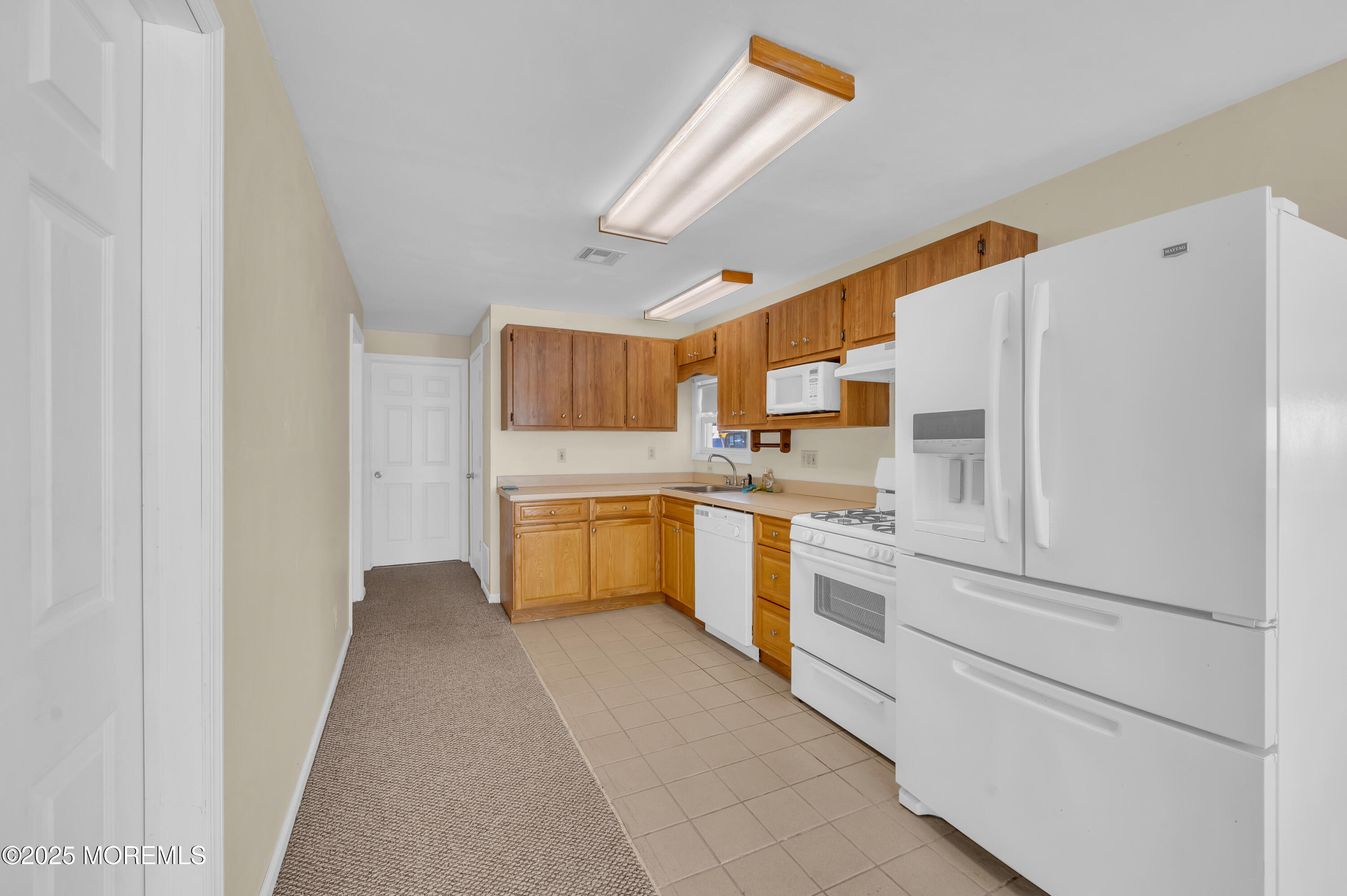 164 North Spinnaker Drive Little Egg Harbor, NJ 08087 - Photo 15 of 33 a kitchen with white cabinets and white appliances