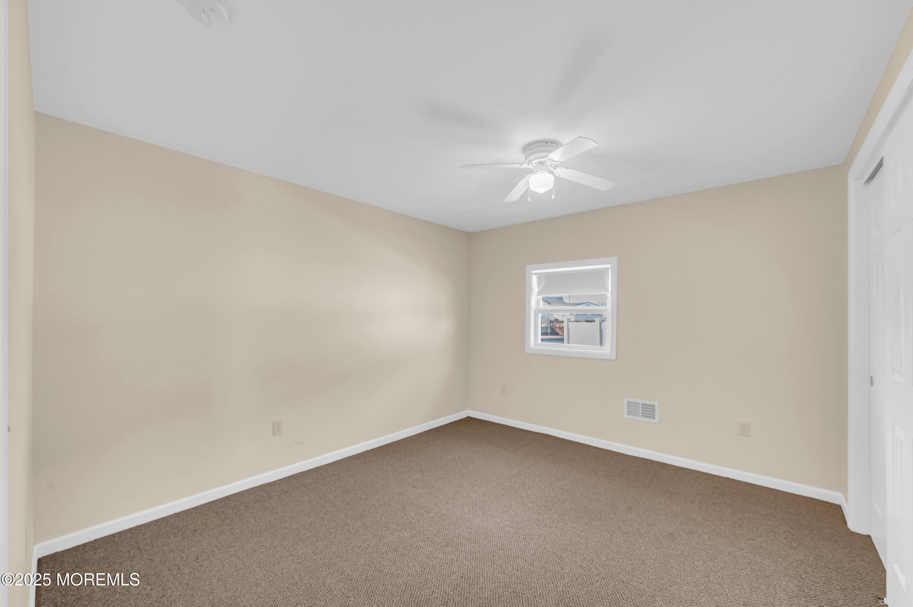 164 North Spinnaker Drive Little Egg Harbor, NJ 08087 - Photo 20 of 33 an empty room with a ceiling fan and a window