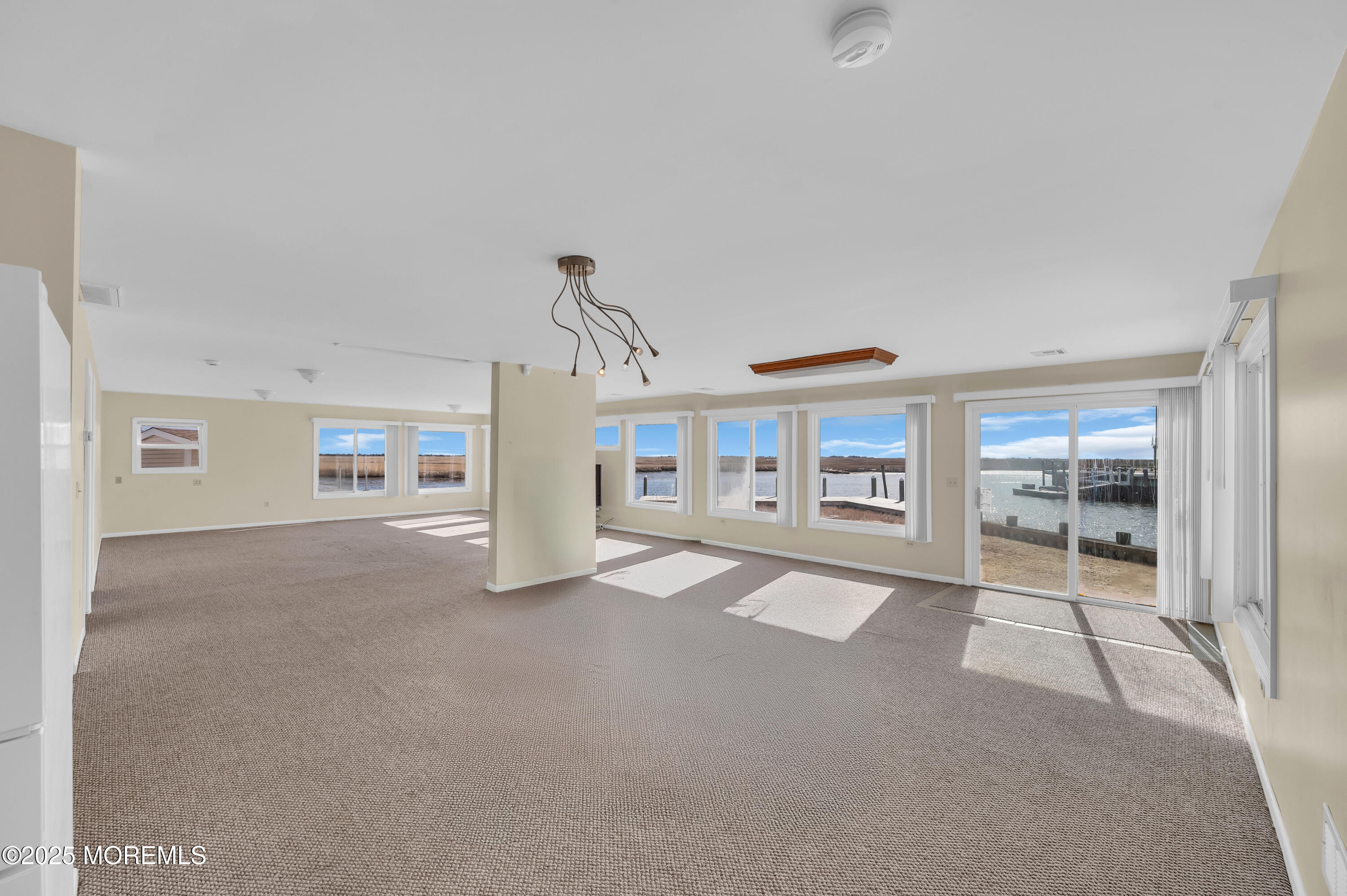 164 North Spinnaker Drive Little Egg Harbor, NJ 08087 - Photo 6 of 33 a big room with chandelier and windows