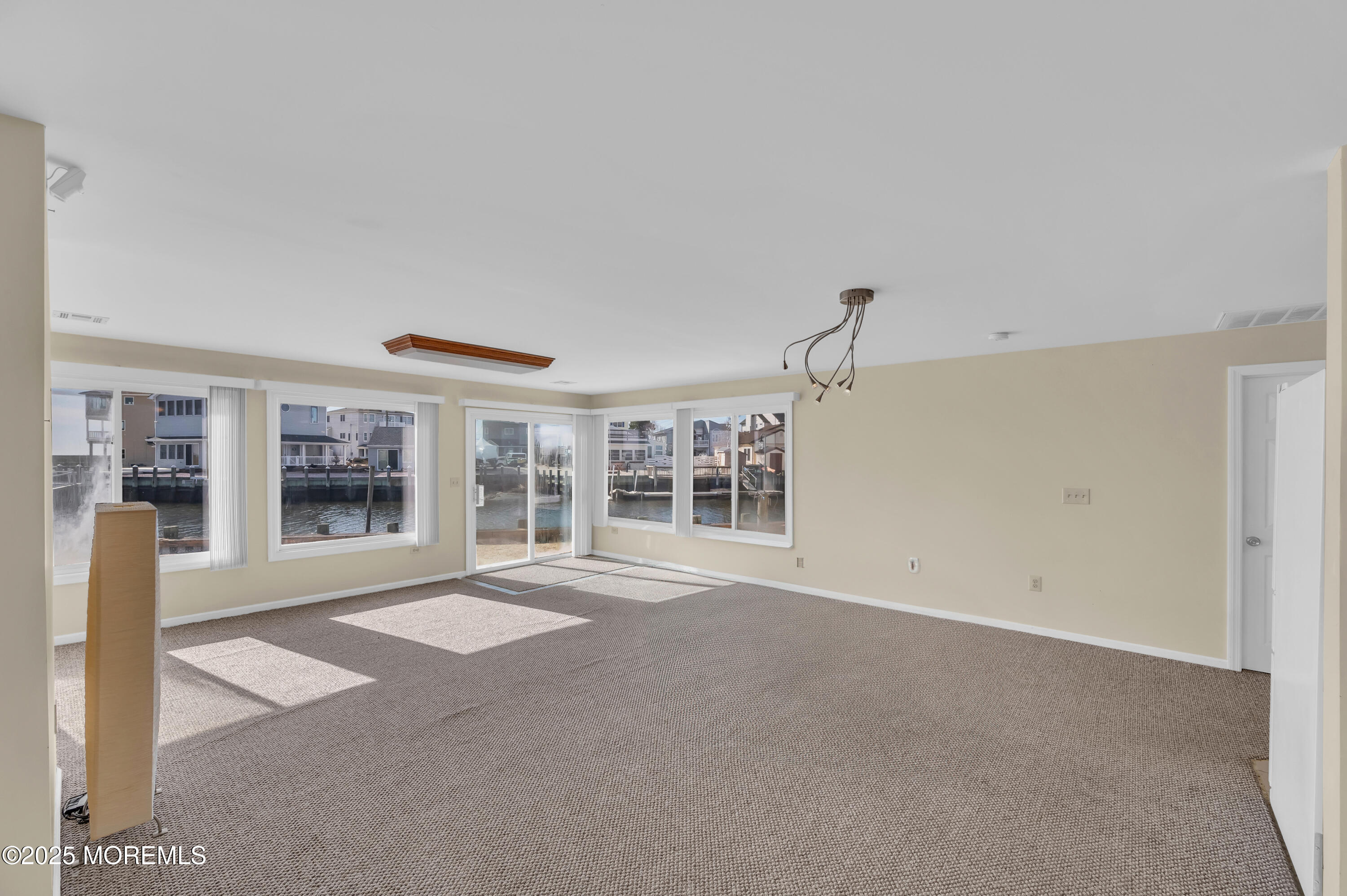 164 North Spinnaker Drive Little Egg Harbor, NJ 08087 - Photo 9 of 33 a view of an empty room with a fireplace and a window