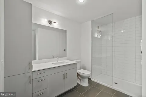 a bathroom with a double vanity sink toilet and shower