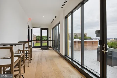 a view of a room with wooden floor and windows