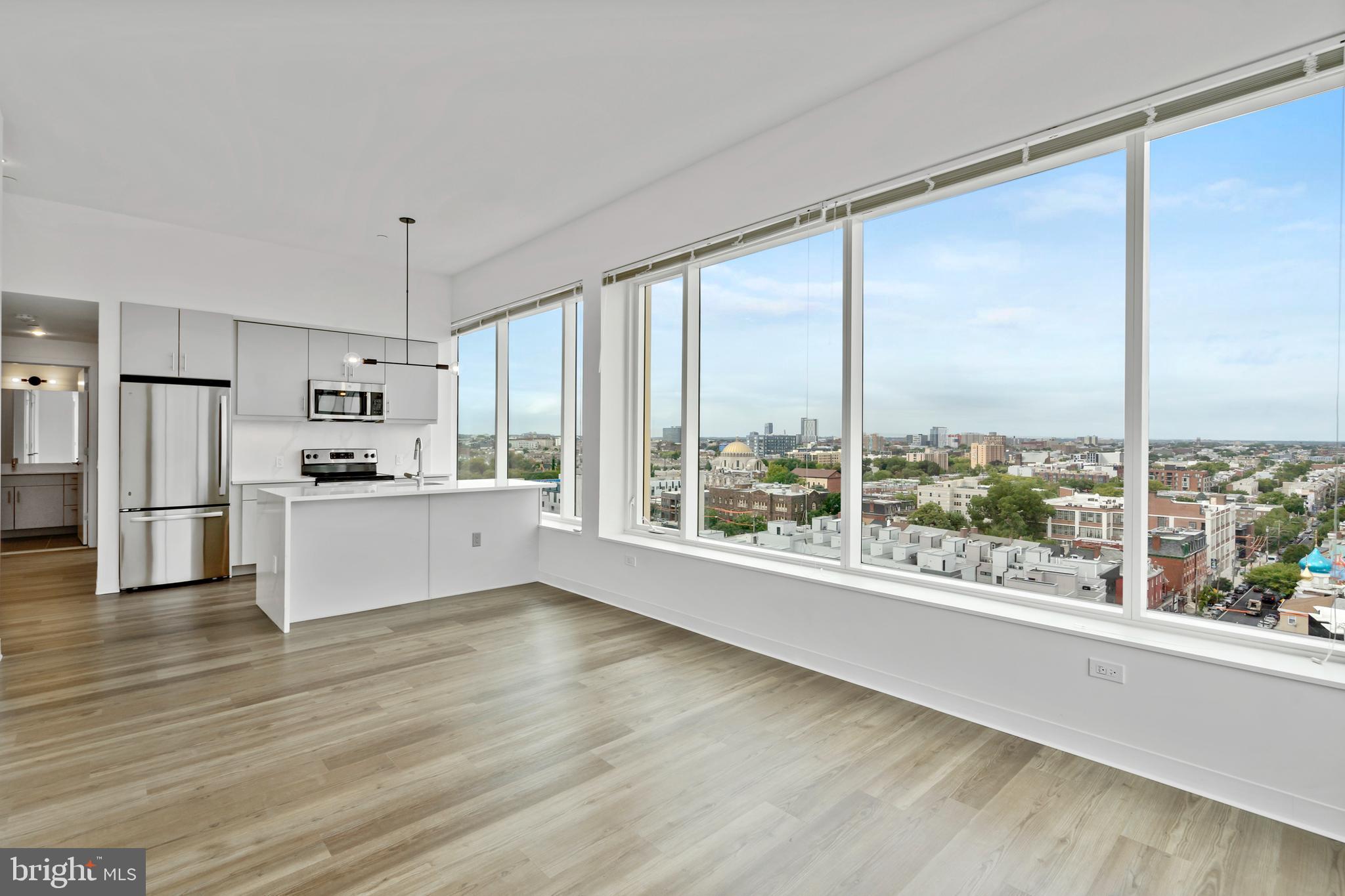 569 North 5th Street, Unit 202 Philadelphia, PA 19123 - Photo 2 of 49 a view of kitchen with stainless steel appliances wooden floor and large window