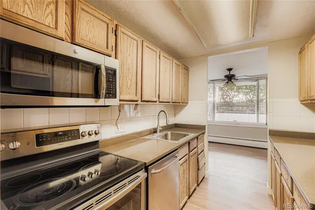 a kitchen that has a sink and a stove