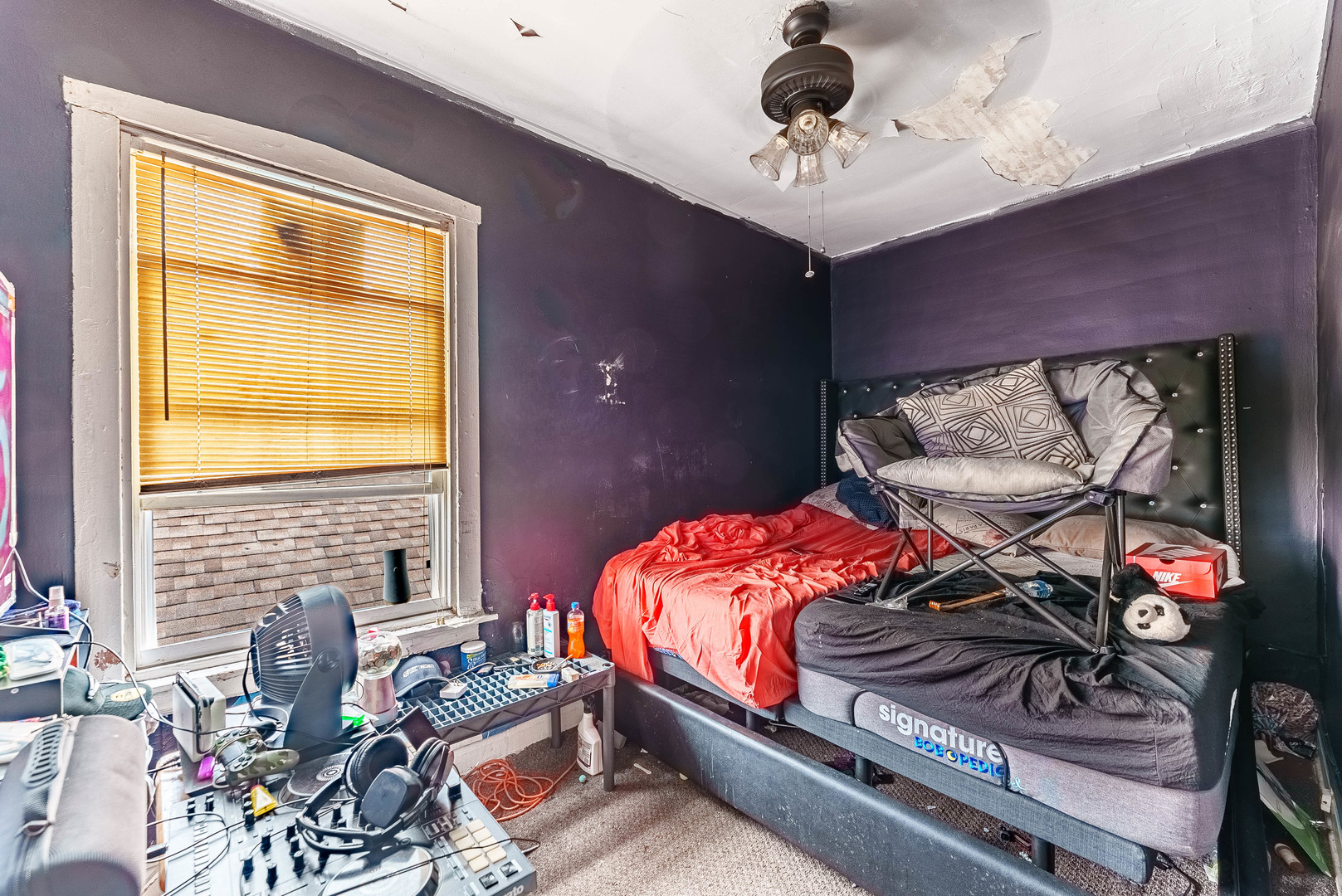 7149 South Wood Street Chicago, IL 60636 - Photo 20 of 26 a bedroom with a bed and a chandelier