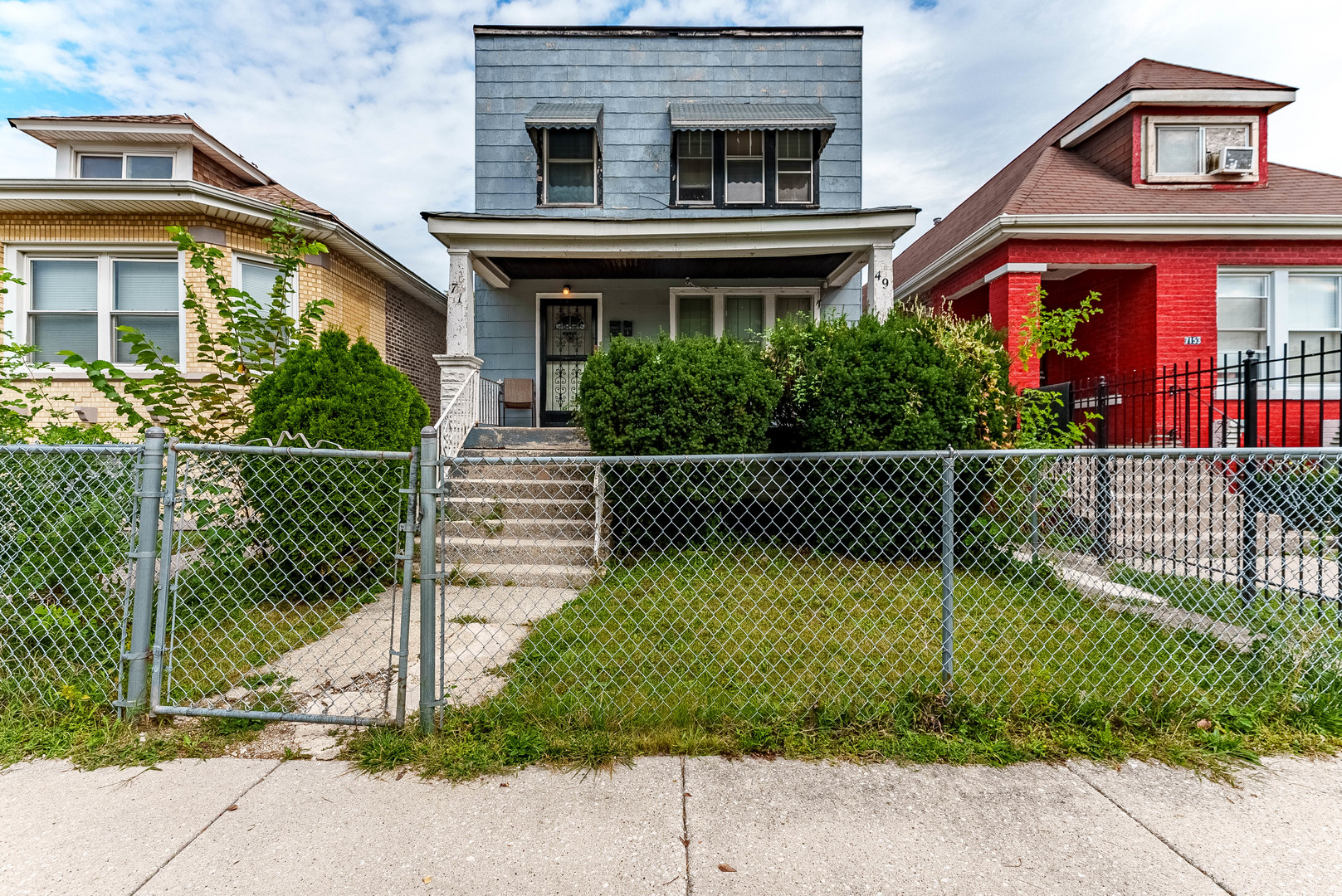 7149 South Wood Street Chicago, IL 60636 - Photo 2 of 26 a front view of a house with a garden