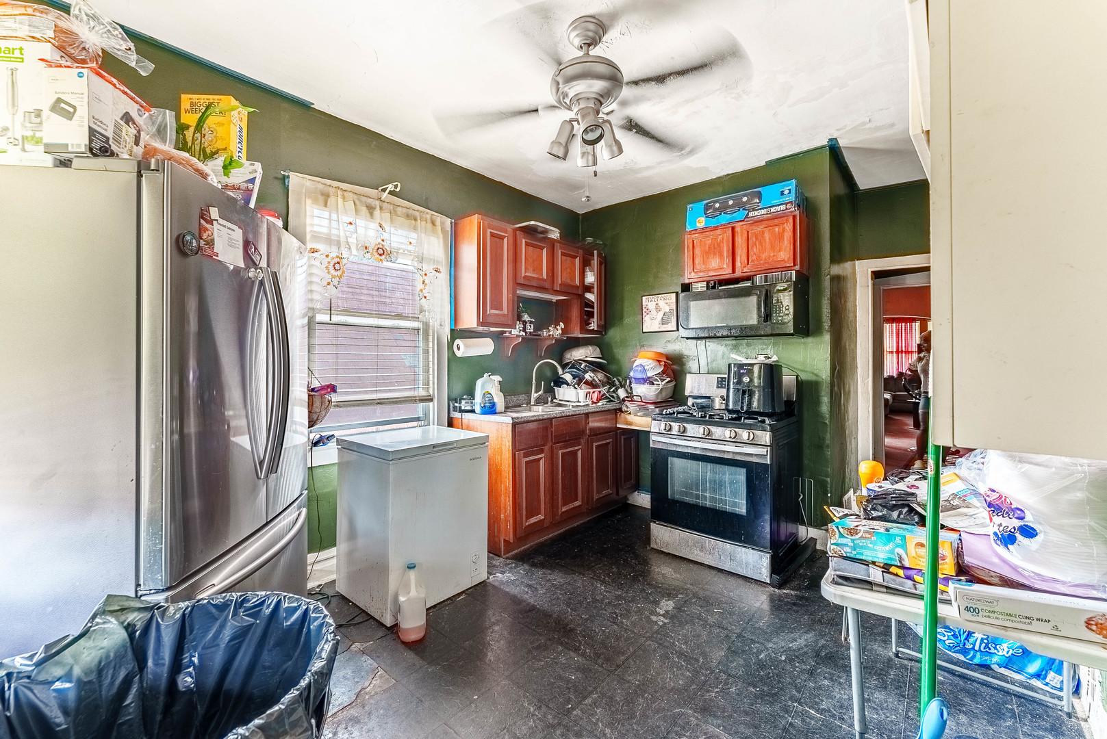 7149 South Wood Street Chicago, IL 60636 - Photo 22 of 26 a kitchen with a refrigerator and a sink
