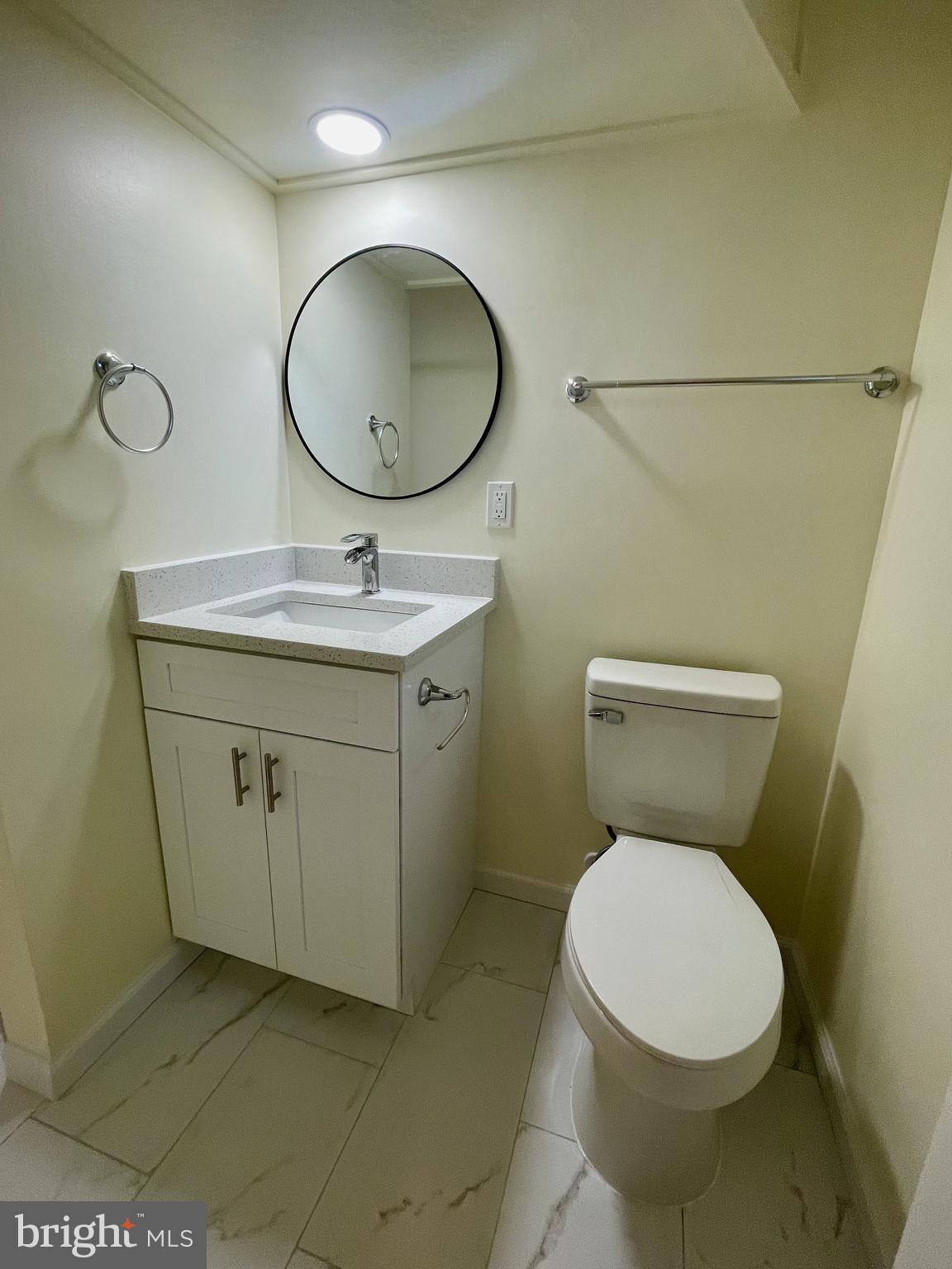 12505 Feldon Street Silver Spring, MD 20906 - Photo 20 of 32 a bathroom with a toilet a sink and mirror