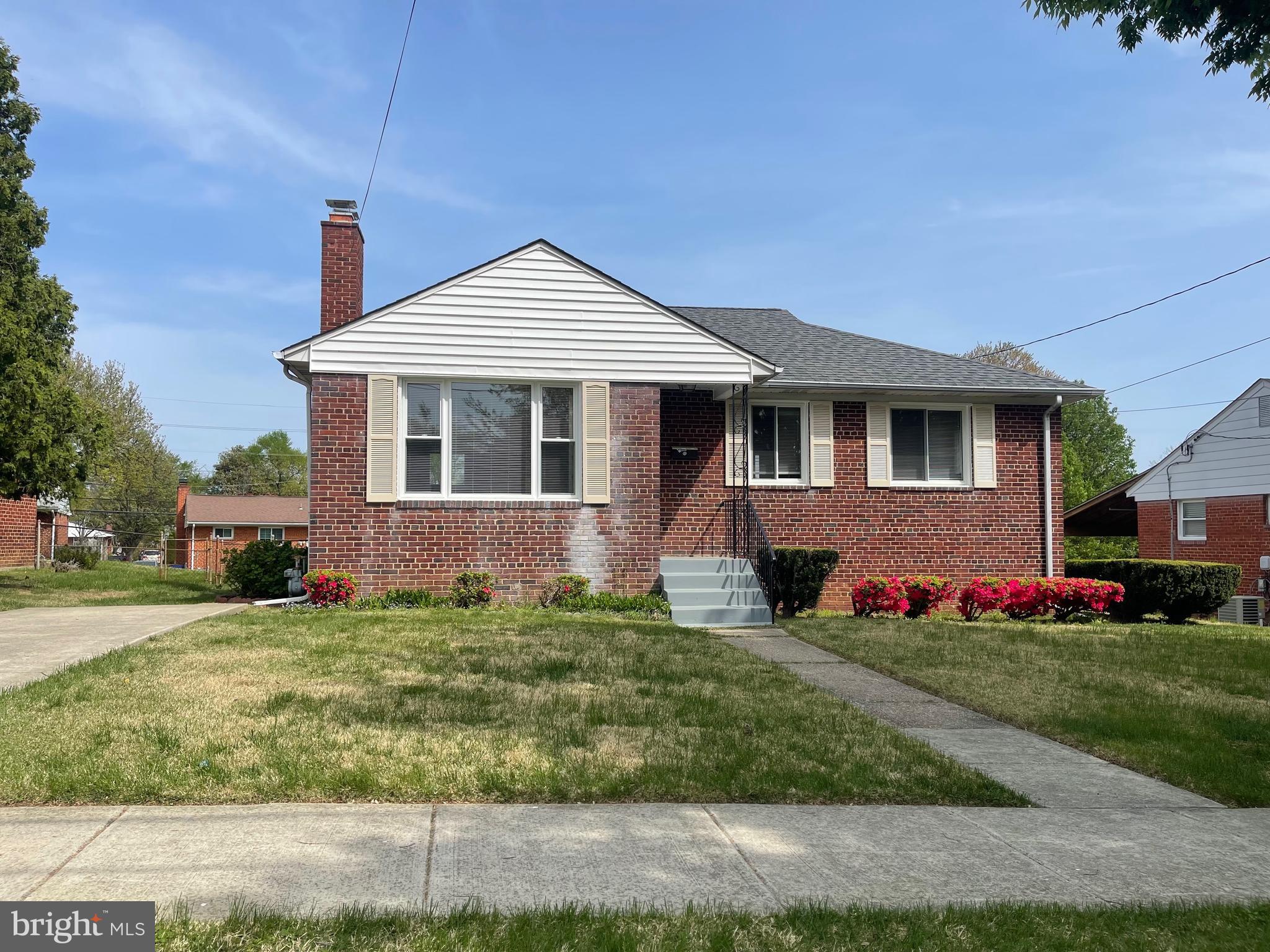 12505 Feldon Street Silver Spring, MD 20906 - Photo 2 of 32 a front view of a house with a yard