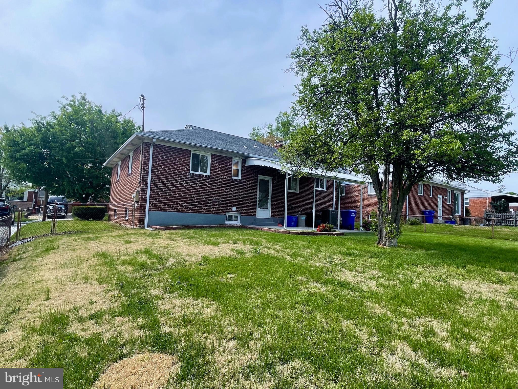 12505 Feldon Street Silver Spring, MD 20906 - Photo 26 of 32 a brick house with a big yard and large trees