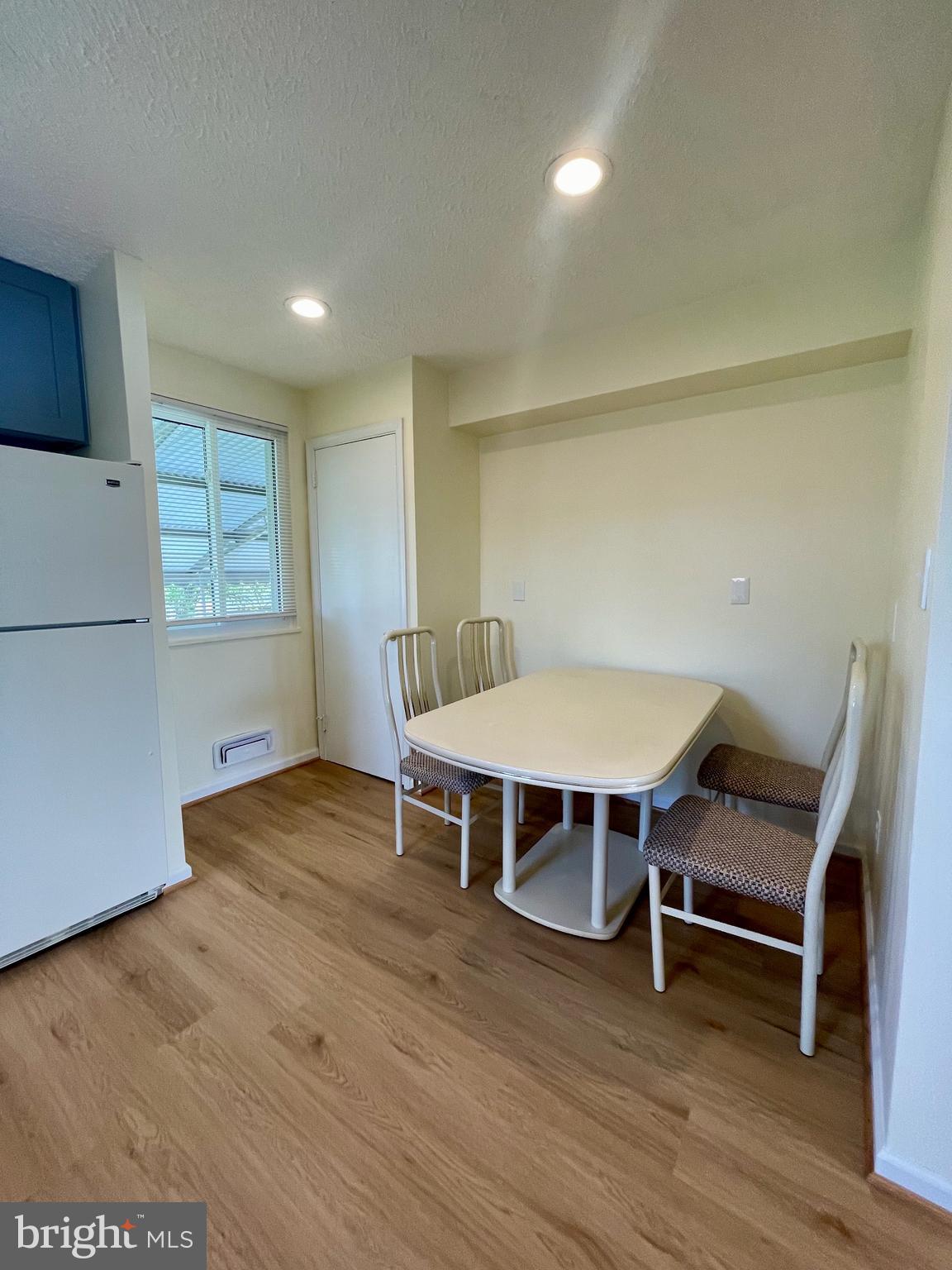 12505 Feldon Street Silver Spring, MD 20906 - Photo 6 of 32 a view of a room with wooden floor table and chairs