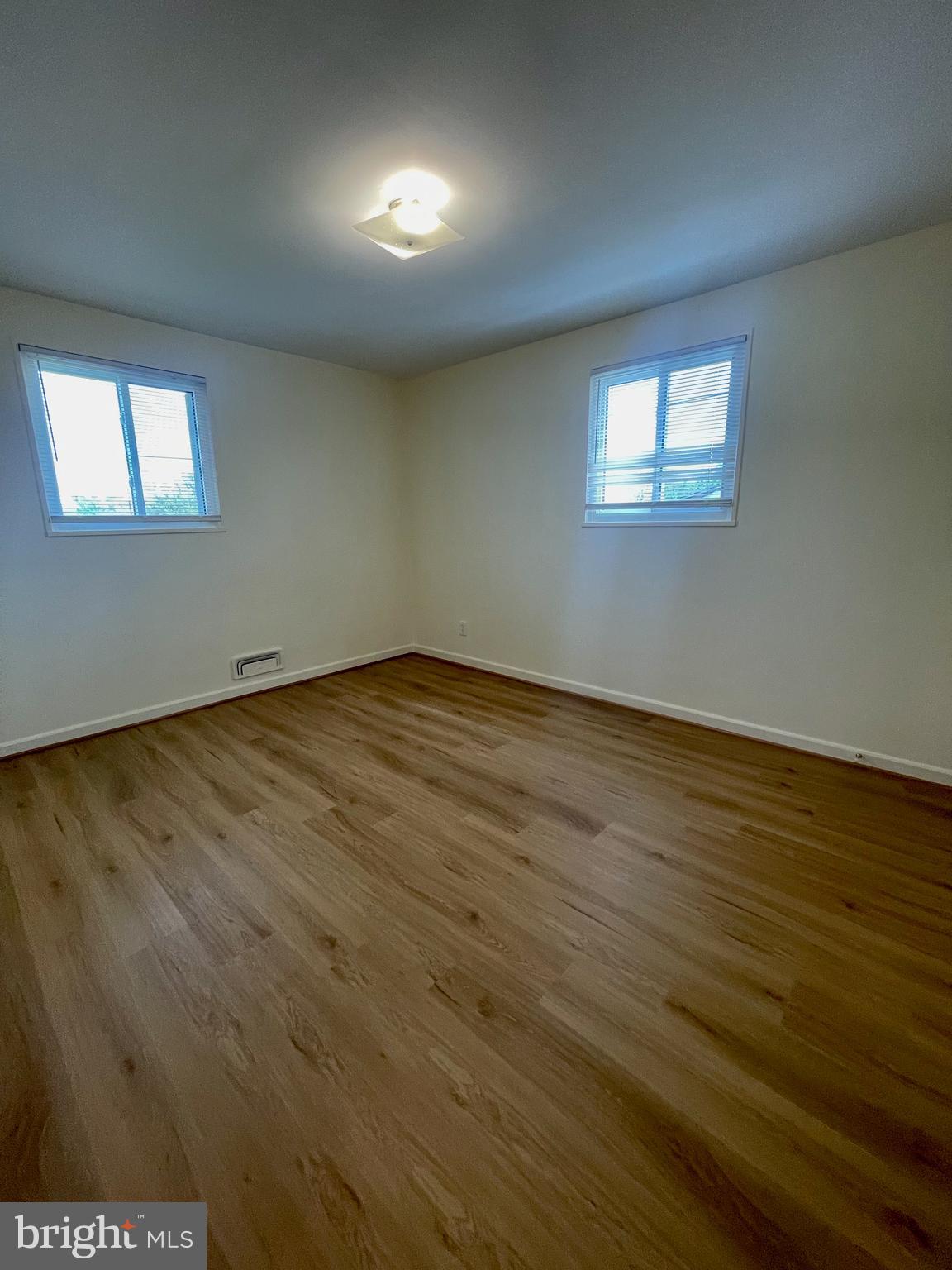 12505 Feldon Street Silver Spring, MD 20906 - Photo 9 of 32 a view of an empty room with wooden floor and a window