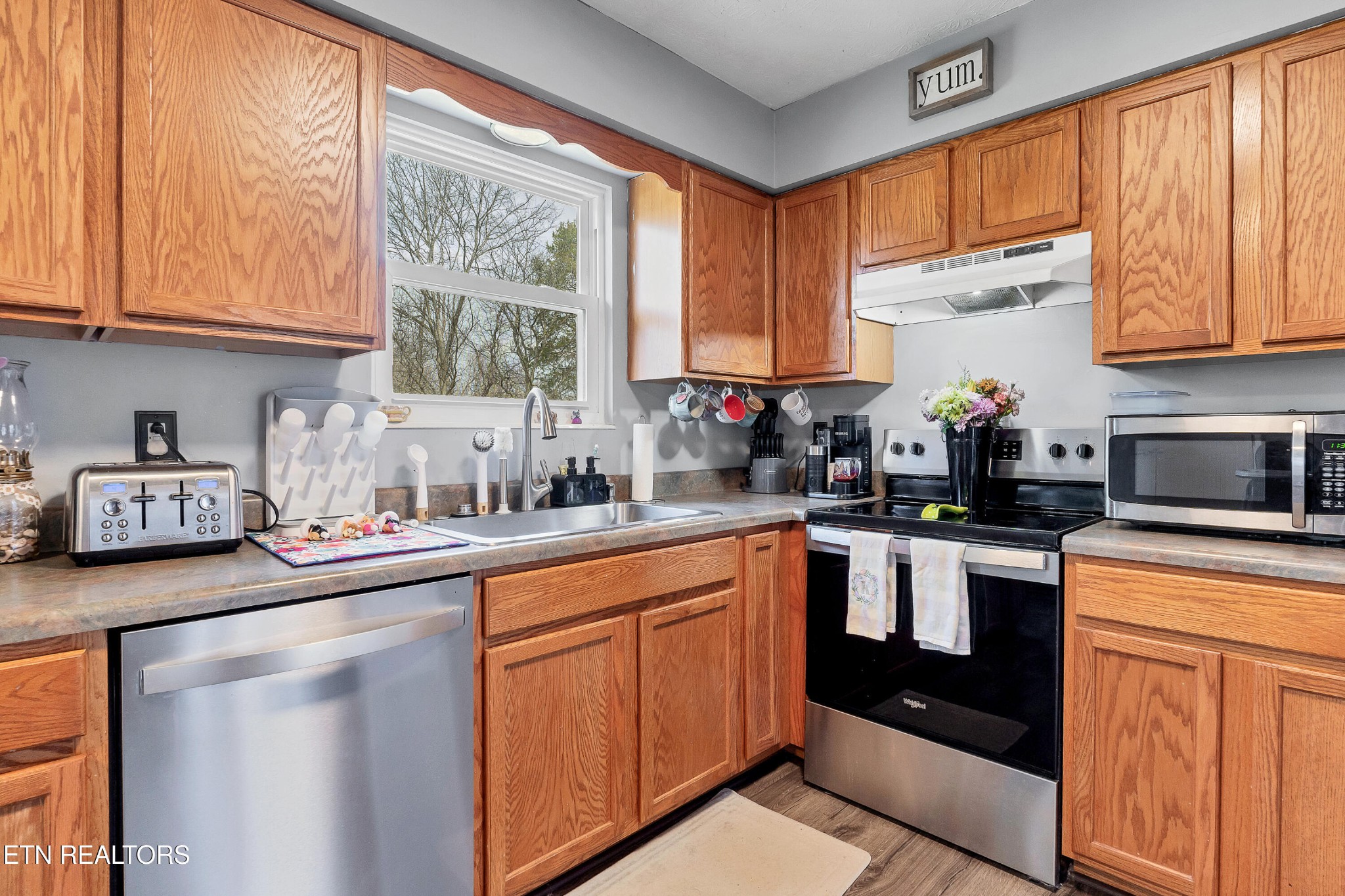 926 Amy Street Seymour, TN 37865 - Photo 8 of 22 a kitchen with stainless steel appliances granite countertop a stove a sink and a microwave