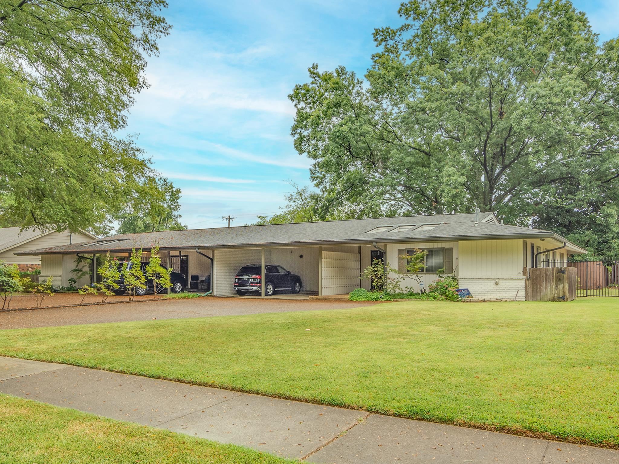 4563 Aldersgate Road Memphis, TN 38117 - Photo 1 of 22 a front view of a house with a yard and trees