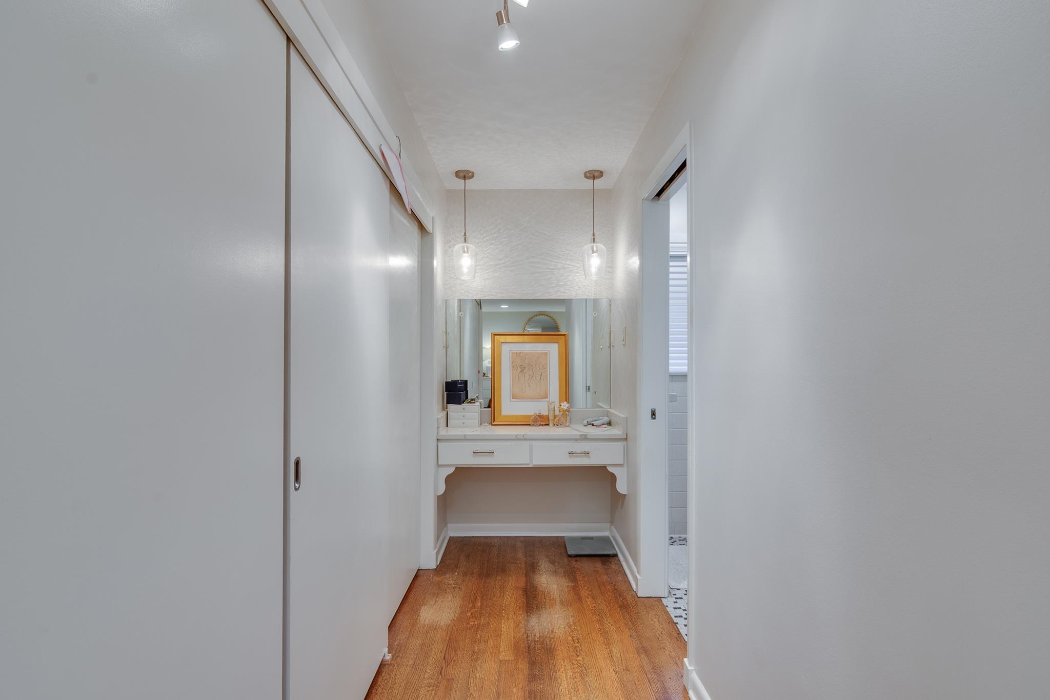 4563 Aldersgate Road Memphis, TN 38117 - Photo 18 of 22 a view of a hallway with wooden floor and a bathroom