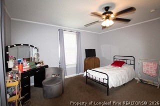 302 North 13th Street Erwin, NC 28339 - Photo 11 of 20 a bedroom with a bed and a chandelier
