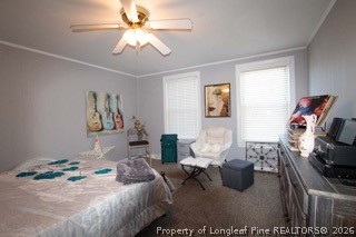 302 North 13th Street Erwin, NC 28339 - Photo 13 of 20 a bedroom with a bed and a chandelier