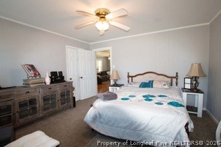 302 North 13th Street Erwin, NC 28339 - Photo 14 of 20 a bedroom with a bed and a chandelier