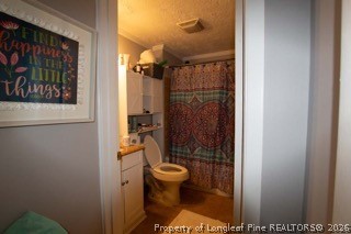 302 North 13th Street Erwin, NC 28339 - Photo 16 of 20 a bathroom with a toilet and a shower