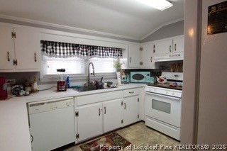 302 North 13th Street Erwin, NC 28339 - Photo 19 of 20 a kitchen with white cabinets and white appliances