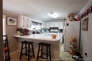 302 North 13th Street Erwin, NC 28339 - Photo 20 of 20 a kitchen with stainless steel appliances a refrigerator and microwave