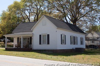 302 North 13th Street Erwin, NC 28339 - Photo 2 of 20 a view of a white house with large windows and a large tree