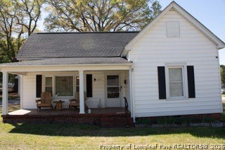 302 North 13th Street Erwin, NC 28339 - Photo 4 of 20 a front view of a house with garden