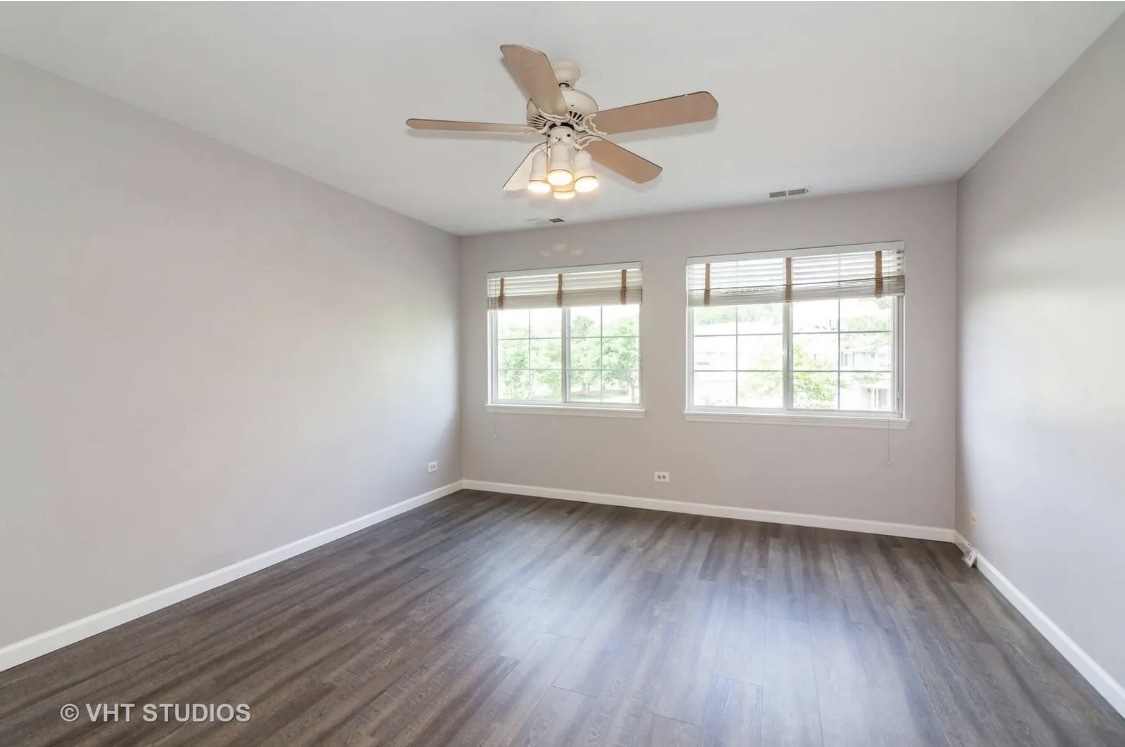 1069 Ripple Ridge Darien, IL 60561 - Photo 6 of 12 wooden floor in an empty room with a window
