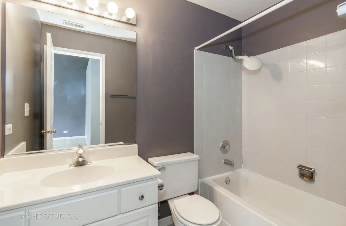 1069 Ripple Ridge Darien, IL 60561 - Photo 9 of 12 a bathroom with a sink a toilet and shower