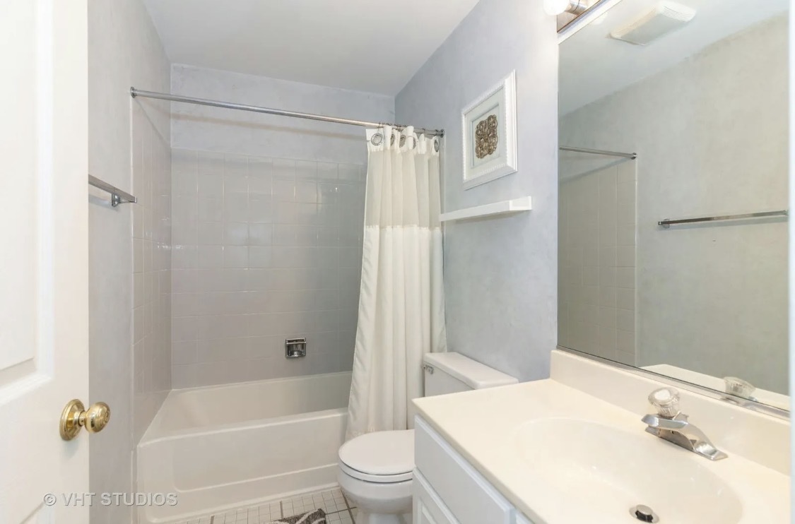 1069 Ripple Ridge Darien, IL 60561 - Photo 10 of 12 a bathroom with a sink toilet and shower
