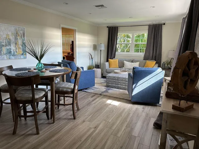 a living room with furniture and a wooden floor