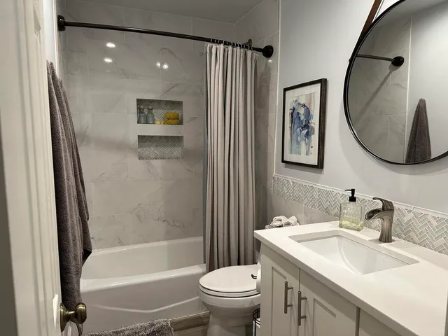 a bathroom with a sink a toilet and a mirror