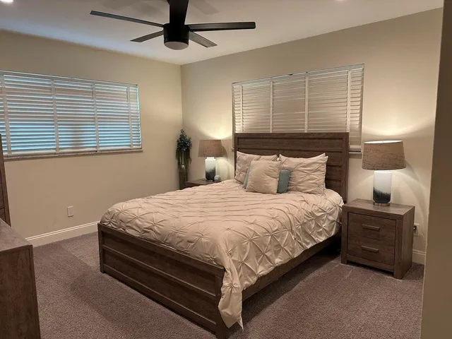 a bedroom with a bed and window