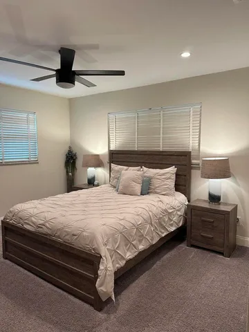 a bedroom with bed and window