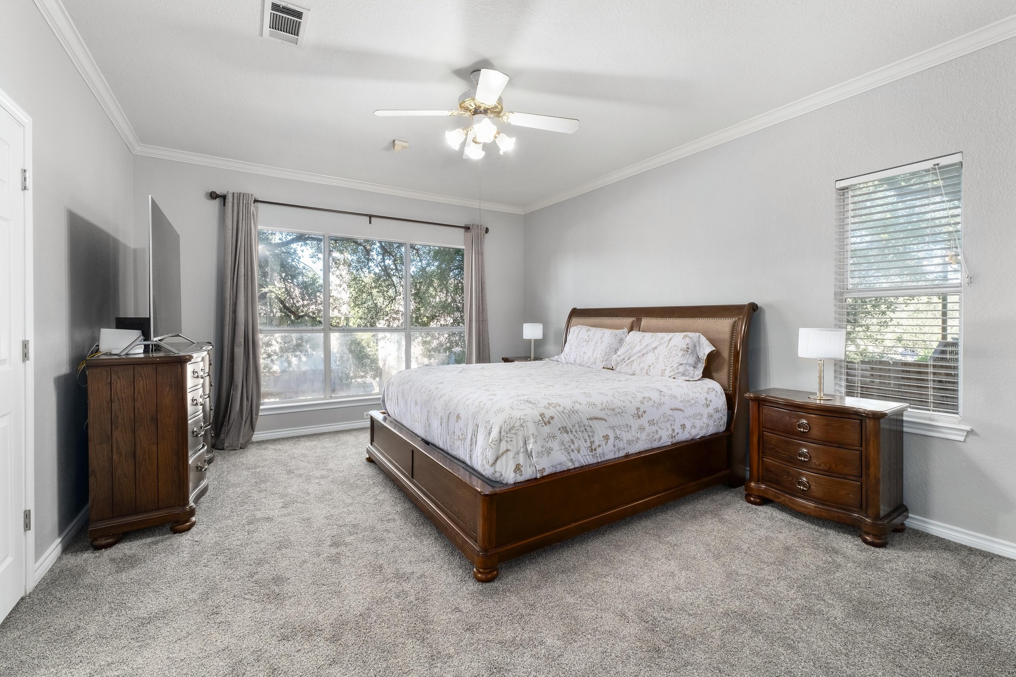 3808 Latimer Drive Austin, TX 78732 - Photo 15 of 30 a spacious bedroom with a bed and a flat tv screen on dresser