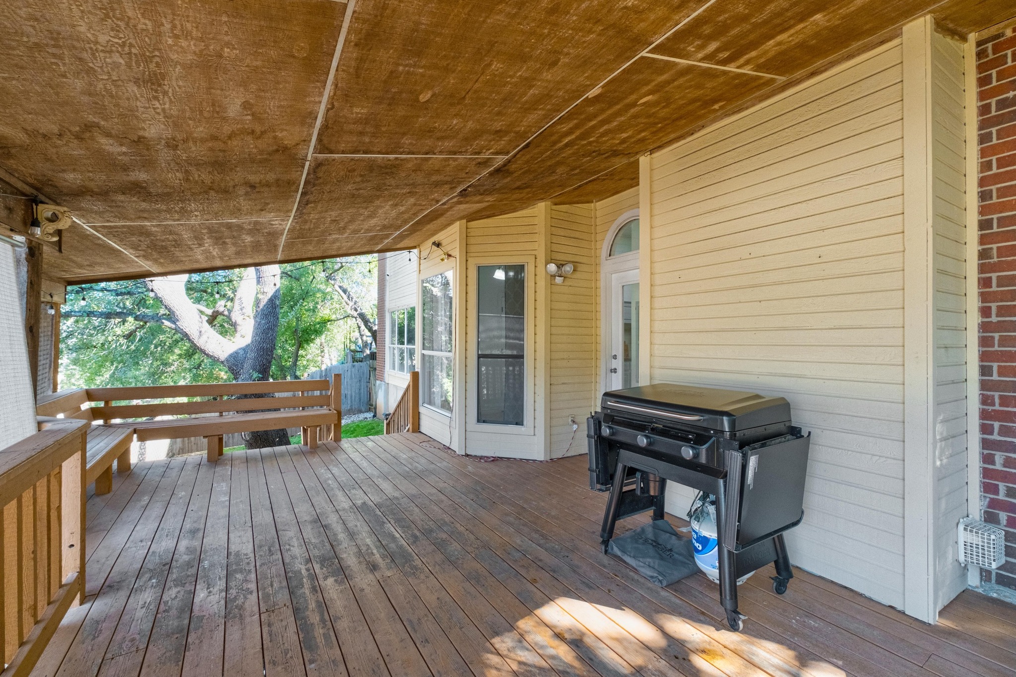 3808 Latimer Drive Austin, TX 78732 - Photo 30 of 30 a view of a patio with table and chairs and wooden floor