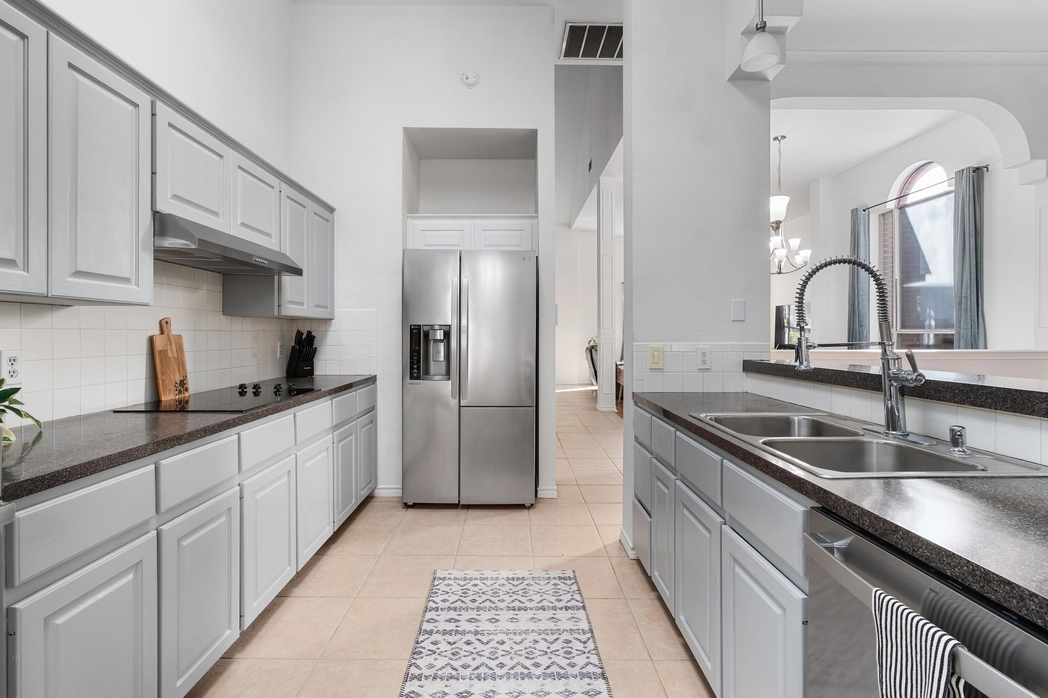 3808 Latimer Drive Austin, TX 78732 - Photo 5 of 30 a kitchen with stainless steel appliances granite countertop a sink and cabinets