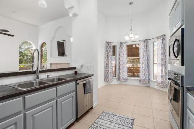 a kitchen that has a sink and a stove