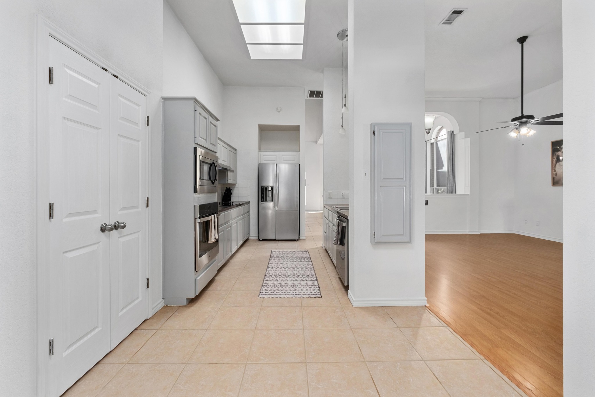 3808 Latimer Drive Austin, TX 78732 - Photo 9 of 30 a view of a hallway with wooden floor and cabinet