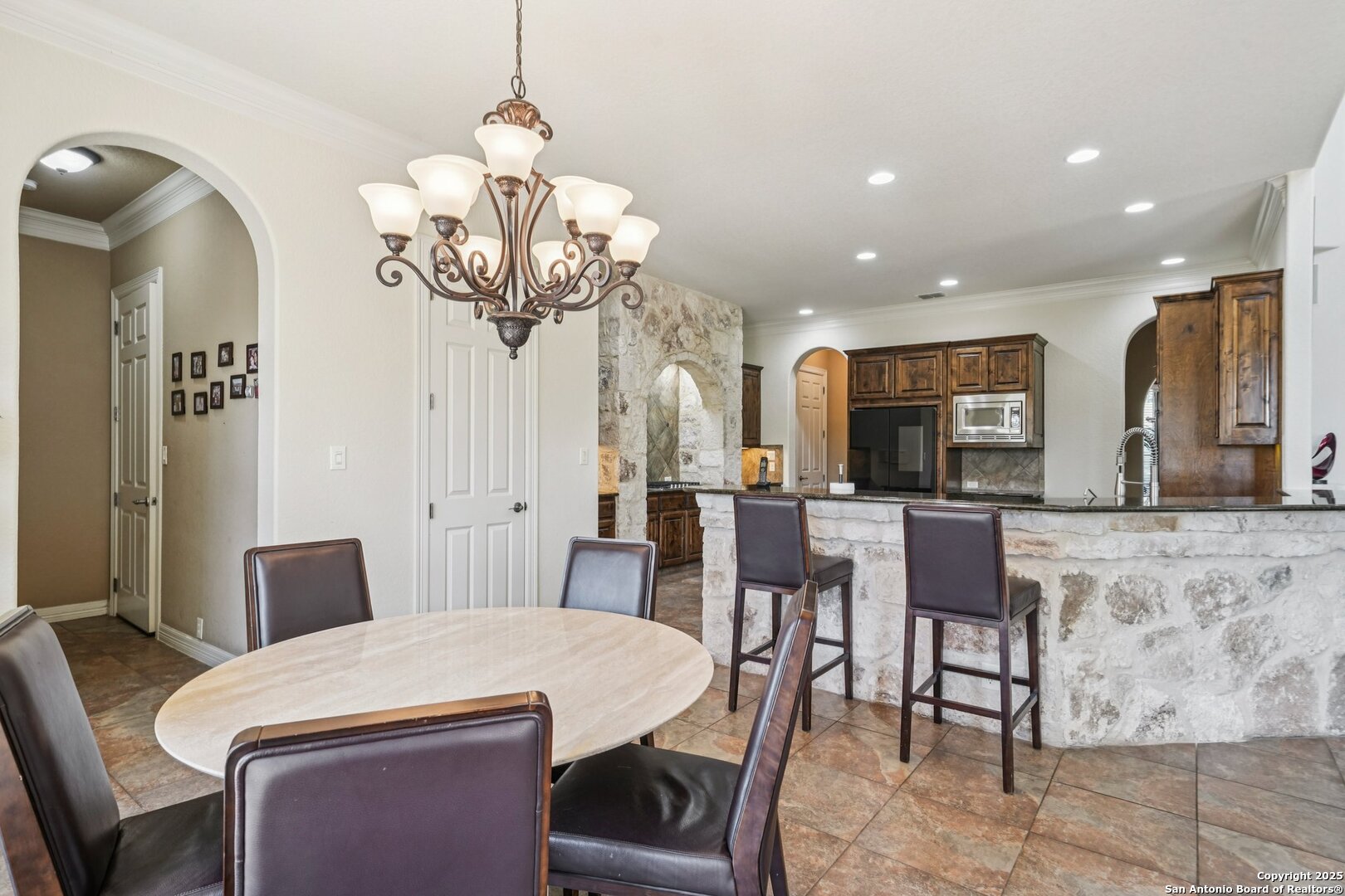 718 Ruidosa Downs Helotes, TX 78023 - Photo 8 of 50 a view of a dining room with furniture and a chandelier