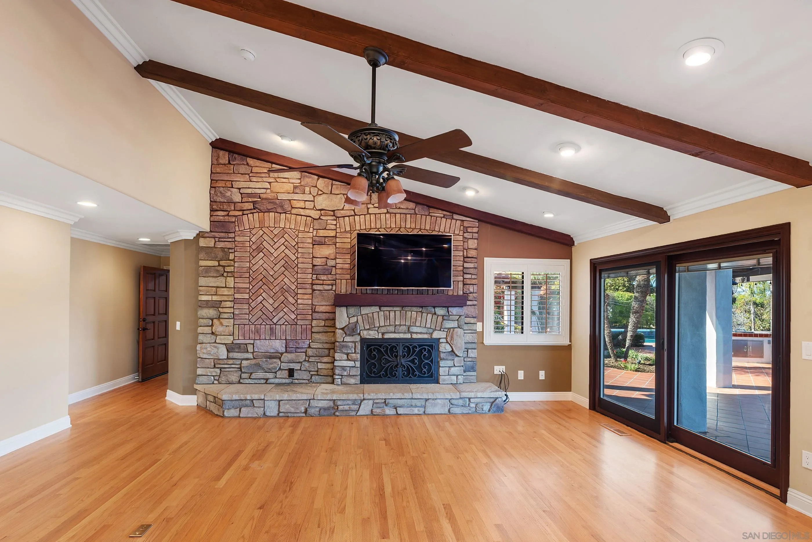 15641 Boulder Mountain Road Poway, CA 92064 - Photo 10 of 75 a view of an empty room with wooden floor fireplace and a window
