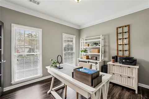 a dining room with furniture a chandelier and wooden floor