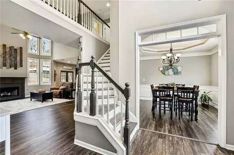 a bedroom with a bed a dresser and painting on the wall